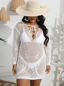 Detailed macro shot of a white crochet lace-up deep V-neck bikini cover-up dress