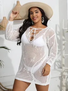 Detailed view of a white crochet beach cover-up dress featuring a sexy lace-up V-neckline