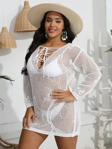 Detailed shot of white plus size crochet beach cover-up with deep V lace-up neckline