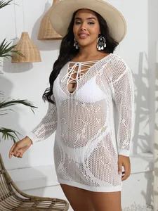 Detailed shot of white crochet V-neck bikini cover-up dress with lace-up front.