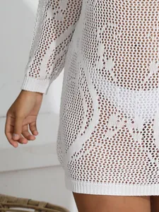 Close-up of white crochet knit mesh bikini cover-up dress with hollow out pattern