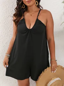 Detail showing the deep V-neck and soft fabric of this plus size black sleeveless romper