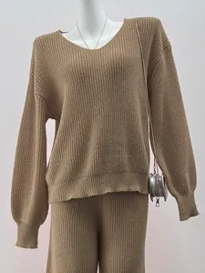 Detailed view of women's khaki V-neck knit sweater set on a mannequin