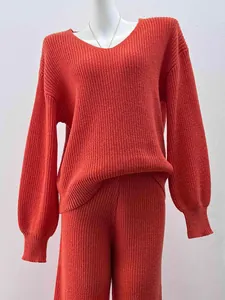 Detailed coarse knit texture of the rust-colored V-neck sweater and wide-leg pants set
