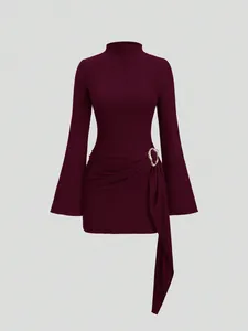 Burgundy textured knit mini dress with flared sleeves and a gold metallic buckle detail.