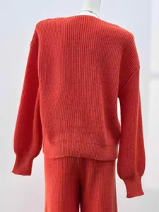 Macro view of a vibrant red knitted sweater set showing premium texture and back fit.