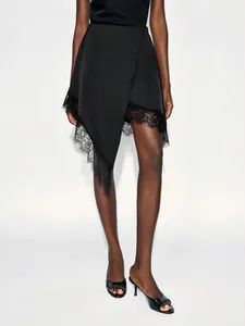 Chic black asymmetrical skirt featuring delicate lace trim and a flattering A-line silhouette