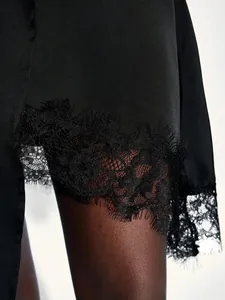 Black satin A-line skirt with delicate eyelash lace patchwork and irregular hemline