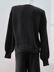 Detailed back view of a minimalist black knitted sweater and matching knit pants set