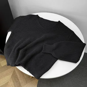 Close-up of black V-neck knit sweater showing detailed ribbed texture