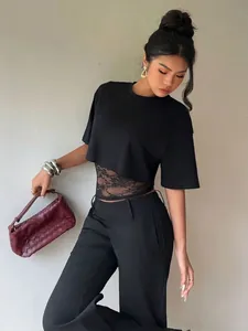 Detailed view of women's black lace patchwork short sleeve crop top with a sexy slim fit design