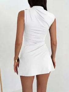 Back view detail of a chic white ruched mini dress with elegant gold metal button accent