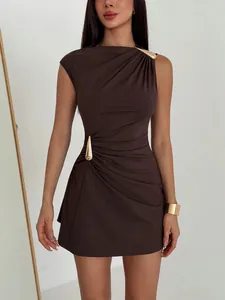 Detail of brown ruched bodycon dress featuring elegant gold-tone metal buckle accents