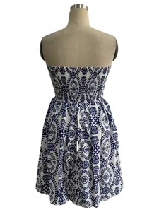 Rear view detail of white strapless mini dress with blue circular floral print on mannequin