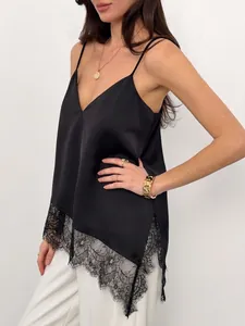 Detail view of a black satin camisole with irregular lace trim and V-neckline