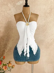 Close-up view of white mesh halter tube top featuring irregular fishtail hem and flower detail