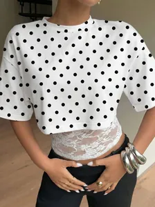 Close-up detail of women's fake two-piece polka dot T-shirt with white lace patchwork