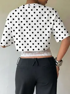 Back view showing the polka dot pattern and white lace patchwork on a stylish crop top