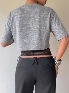 Detailed back view of a grey heathered short-sleeve crop top featuring black lace patchwork