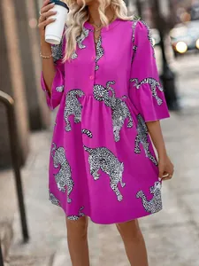 Elegant magenta mini dress featuring a bold leopard print and stylish flare sleeves.