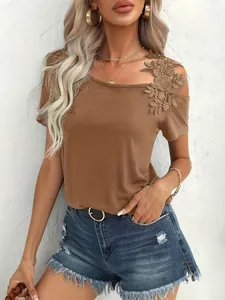 Detail of brown women's T-shirt featuring delicate floral lace appliqué on shoulder