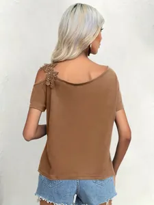 Back view of a brown summer T-shirt featuring intricate floral lace on the shoulder