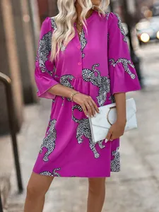 Elegant summer dress with magenta leopard print, buttoned V-neck and bell sleeves.