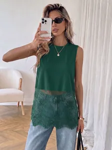 Detailed view of women's dark green sleeveless top featuring elegant floral lace patchwork hem.