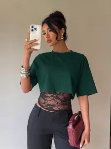 Detail shot of a stylish sexy green fake two-piece T-shirt with black lace patchwork.