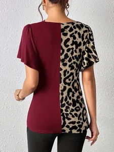 Detail view of women's patchwork top featuring leopard print and burgundy panels.