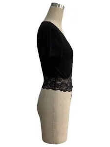Side view detail of a slim-fit black short-sleeved top with elegant lace hem.
