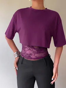 Detailed view of women's purple crop top with lace layered bodice and short sleeves.