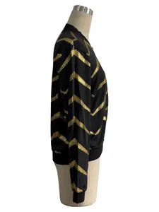 Detailed side profile of women's black bomber jacket with elegant gold zigzag print