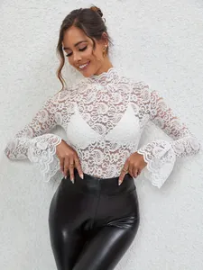 Elegant detail of white paisley lace top featuring high neck and stylish flared bell sleeves