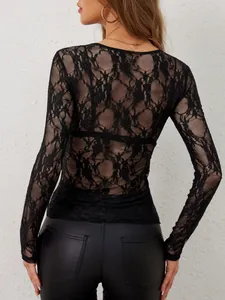 Close-up of the elegant black floral sheer lace pattern on back of long sleeve top