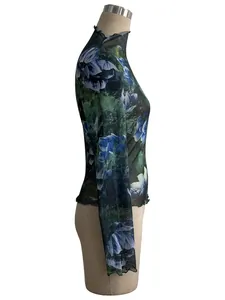 Side profile of a floral print mesh top with stand collar and lettuce edge on a mannequin