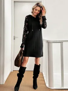 Elegant black hooded mini dress featuring delicate lace raglan sleeves and drawstring