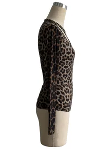 Detailed side view of women's leopard print hollow round neck tight long-sleeved top on mannequin