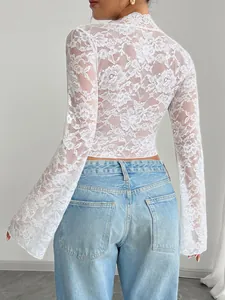 Back view detail of elegant white lace top with flared sleeves and floral pattern
