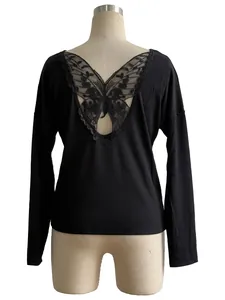 Close-up of the back detail showing the black lace butterfly applique on a ribbed shirt