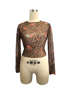 Close-up detail of women's leopard and rose floral print mesh long sleeve crop top