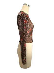 Detailed side view of a leopard and floral print mesh crop top on a mannequin.