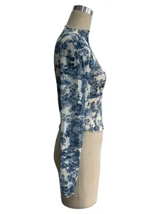 Side profile detail of women's sheer mesh long sleeve cropped top with blue toile print