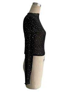 Close-up of black transparent mesh long sleeve T-shirt with silver sequin details