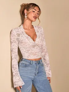 Elegant white lace V-neck long sleeve top with flare sleeves and floral pattern