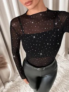 Close-up of sheer black mesh long sleeve top with colorful rhinestone sparkles