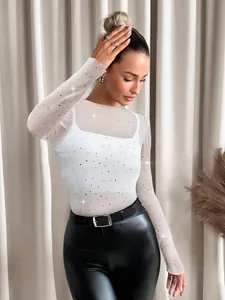 Detailed view of women's white sheer mesh top featuring sparkling rhinestone accents.