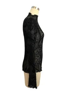 Detailed side view of black paisley flocked mesh top with mock neck and lettuce edges