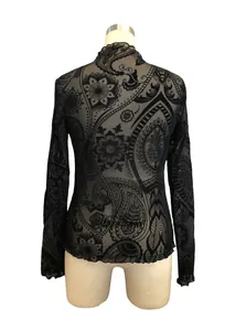 Exquisite detail of paisley flocking on black mesh long sleeve T-shirt with lettuce trim.
