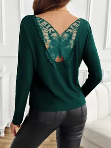 Detail view of woman's dark green ribbed top featuring elegant butterfly lace back design.